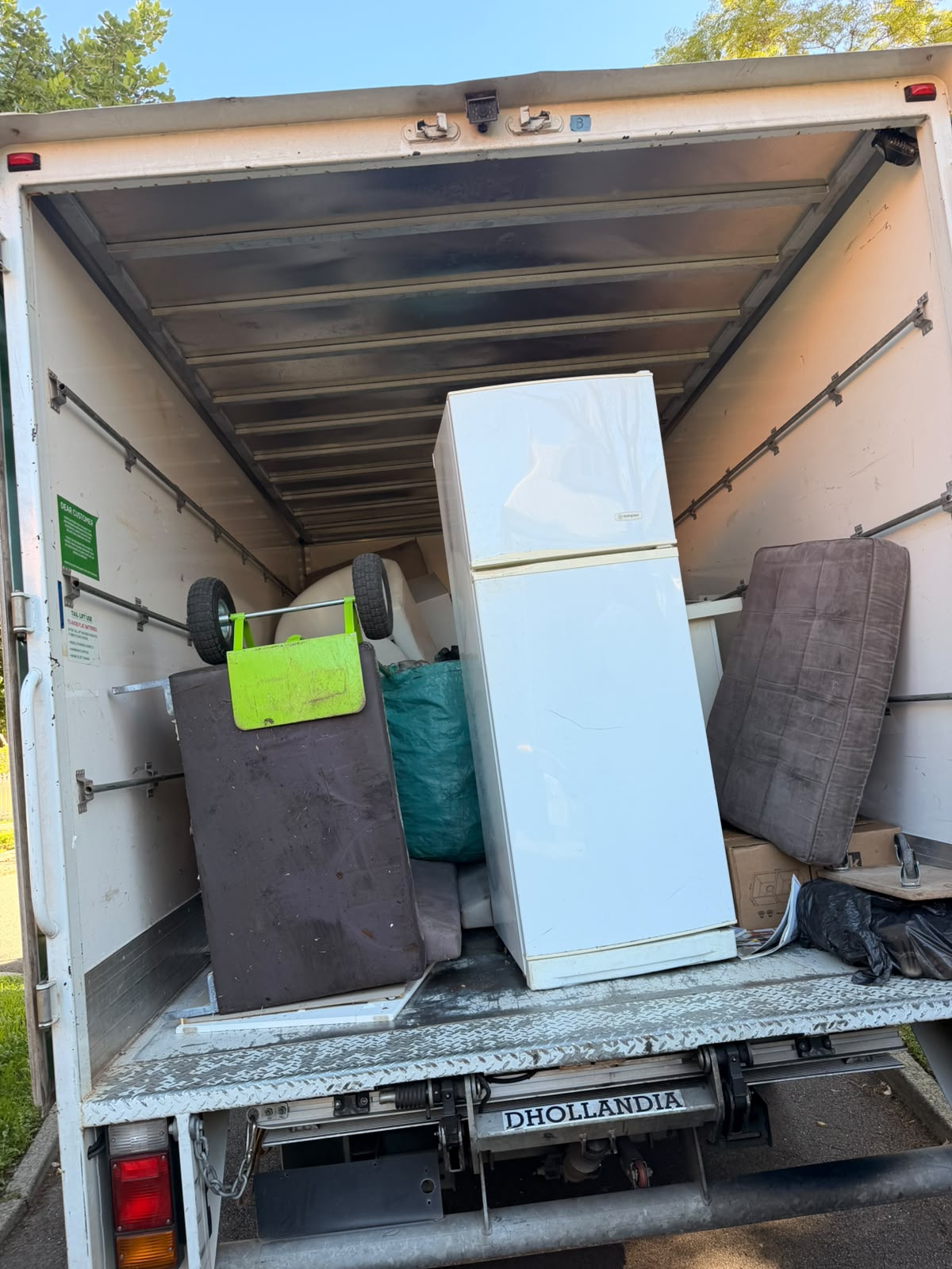 Truck loaded with fridges, mattresses, and heavy whitegoods