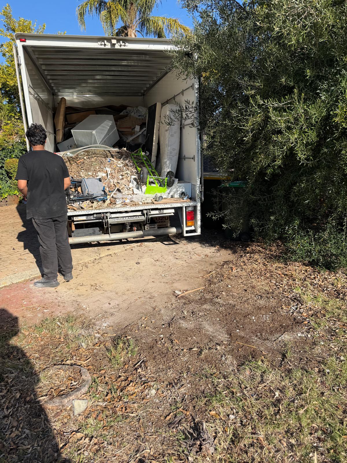 Perth Rubbish Removal Team Member loading Isuzu truck